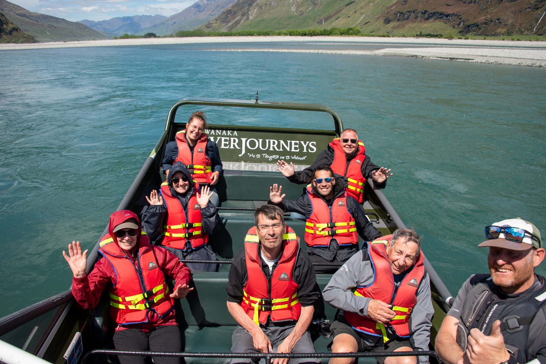 Guests on the jet boat looking up the braided West Matukituki towards the mountains of Mount Aspiring National Park